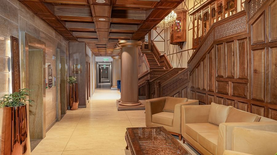 An inviting seating area with cosy sofas, a teapoy, and a staircase elegantly leading to the upper floors - Sarovar Premiere, Srinagar